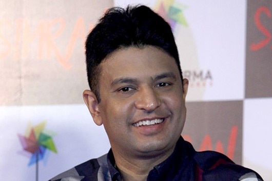 Bhushan Kumar sitting and smiling