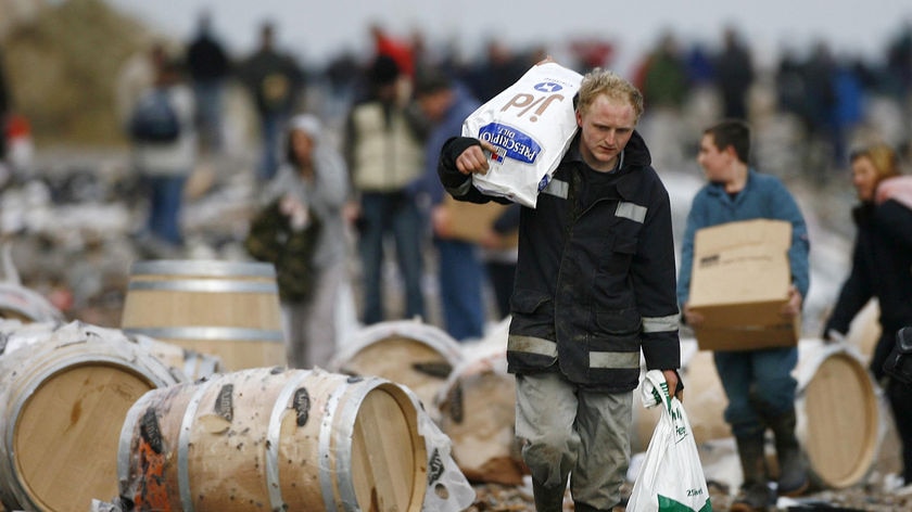 People look for salvageable goods from the wreck of the MSC Napoli on the beach at Branscombe, January 22, 2007.