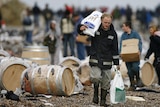 People look for salvageable goods from the wreck of the MSC Napoli on the beach at Branscombe, January 22, 2007.