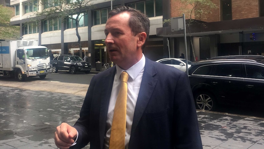 Mid shot of Mark McGowan wearing a yellow tie on a street in Sydney.