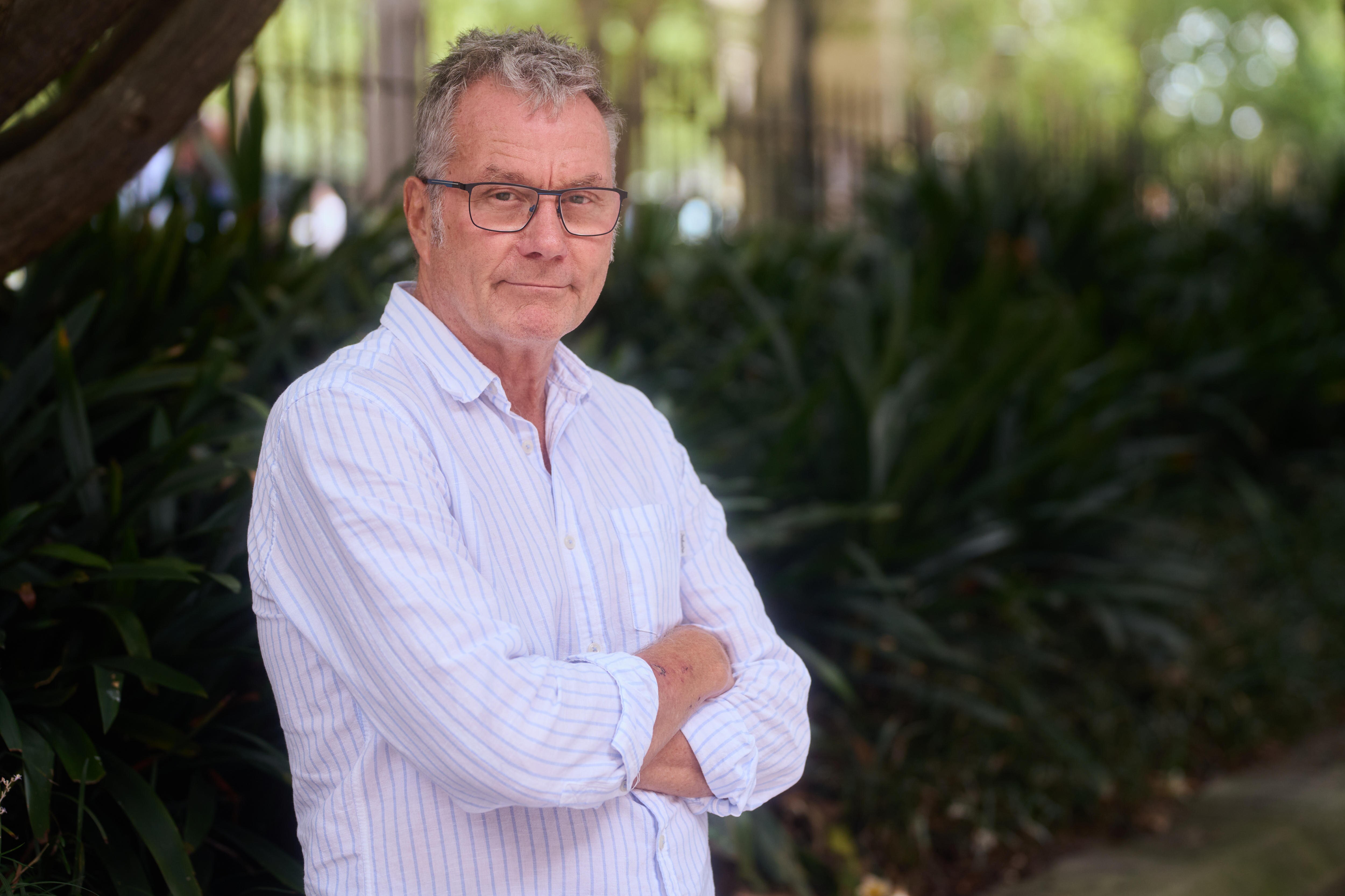 A man in a white shirt wearing glasses