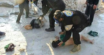 Workers hose down children in suspected Syria gas attack