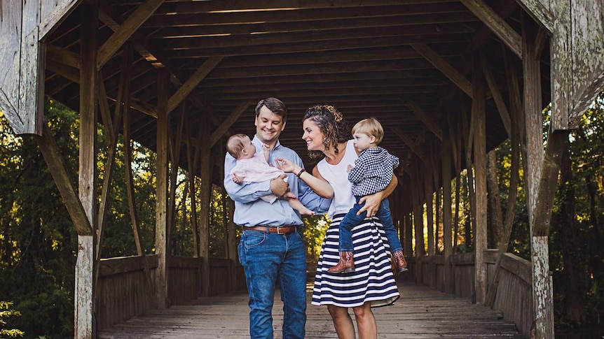 Luke Letlow and his wife hold their young children.