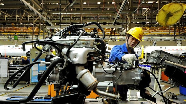 An employee works on a car in China