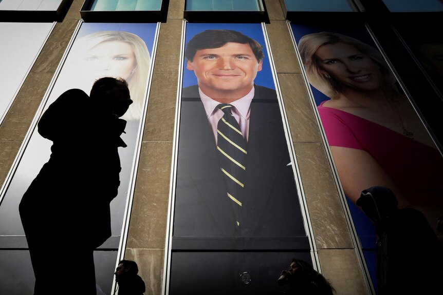 Tucker Carlson's poster on the side of a building