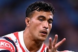A Sydney Roosters NRL player catches the ball during a warm-up before a match in 2023.