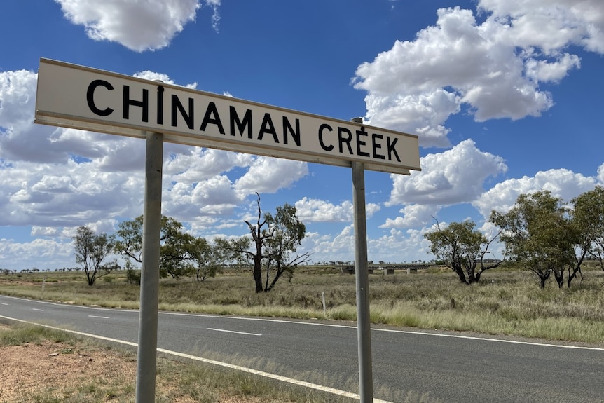 Road sign that says 'chinaman creek' on an outback road. 