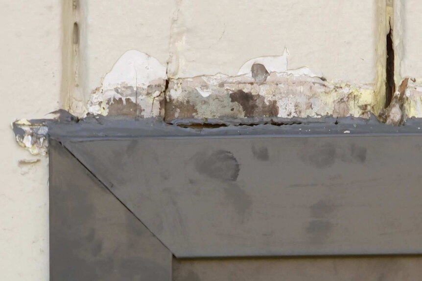 Close up of peeling paint on a window frame.