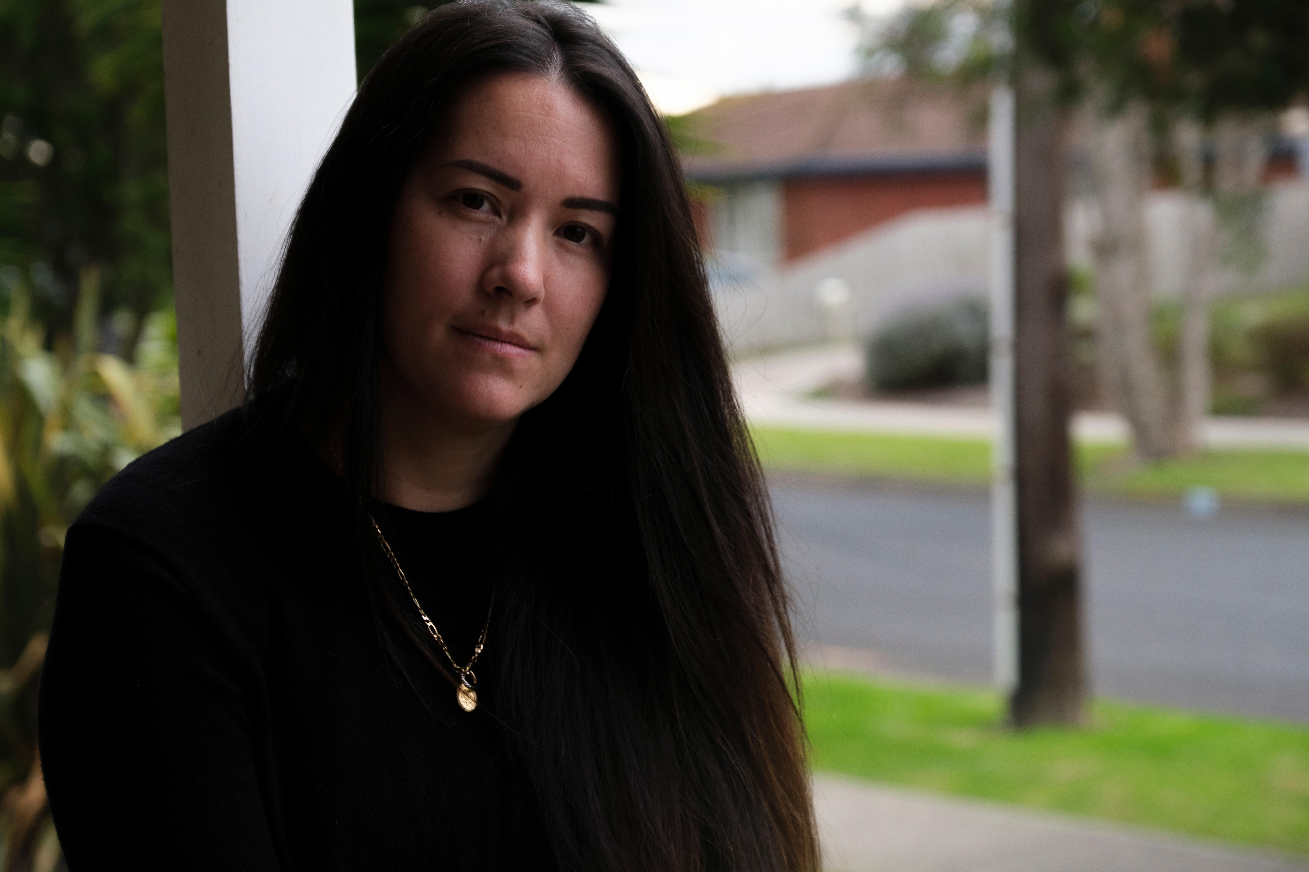 a portrait photo of Teegan on a suburban street 