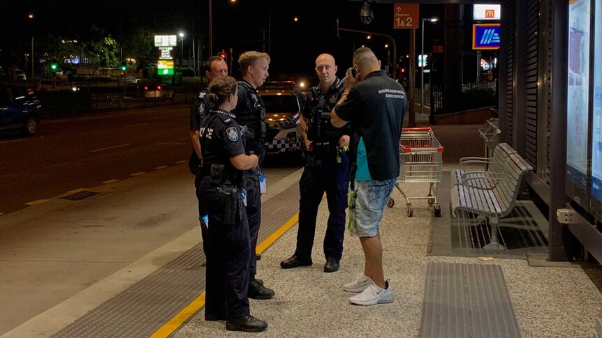 Police and Mike Carter at a bus station in logan