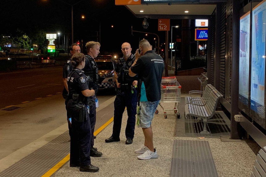 Police and Mike Carter at a bus station in logan