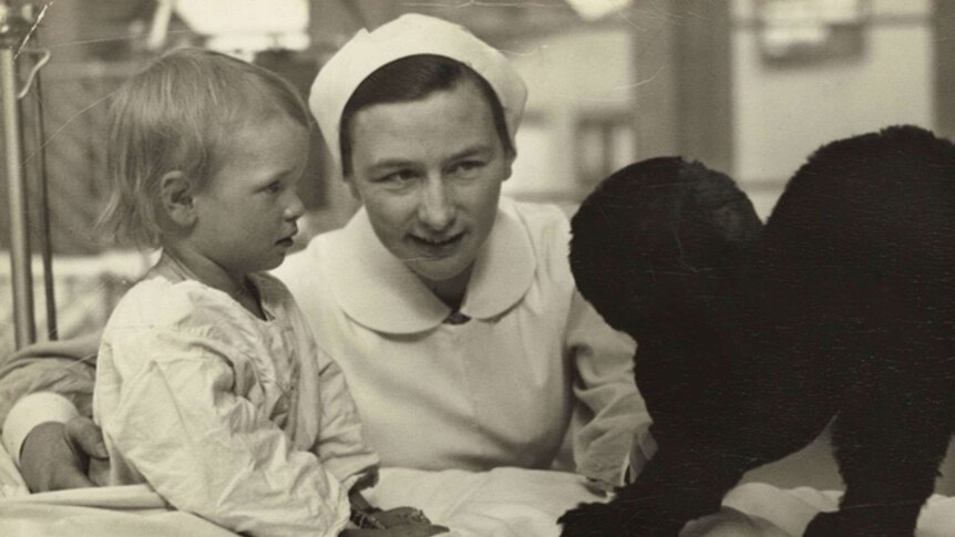 Nurse Kathleen Neuss with a young child and dog.