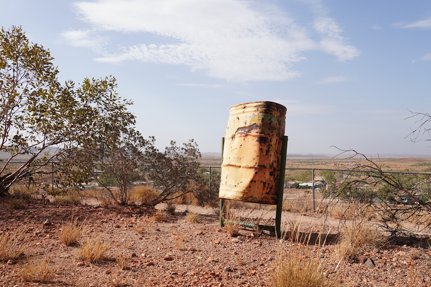 a rusted yellow bin on top of a hill in Marble Bar, Western Australia.