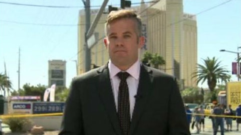 Conor Duffy standing on the Las Vegas strip in front of police tape.