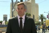 Conor Duffy standing on the Las Vegas strip in front of police tape.