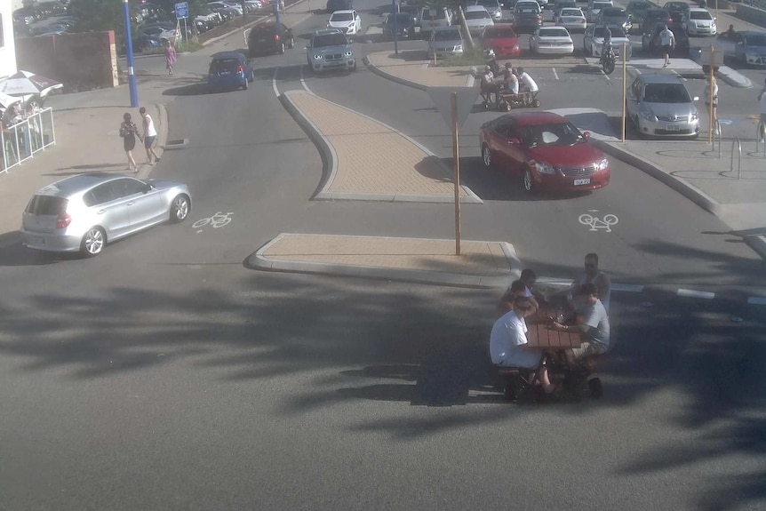 Men ride motorised picnic tables in the Scarborough Beach area