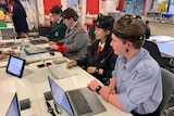 Students wearing ECG headsets while sitting at their computers.