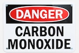 A back, white and red sign reading 'danger, carbon monoxide' in bold letters.