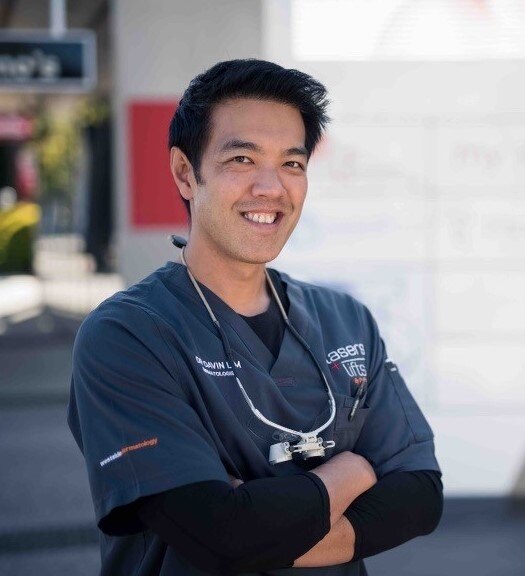 dr davin lim smiles as he poses for a picture