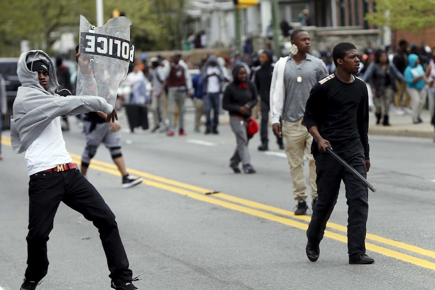 Demonstrators throw rocks at Baltimore police during clashes