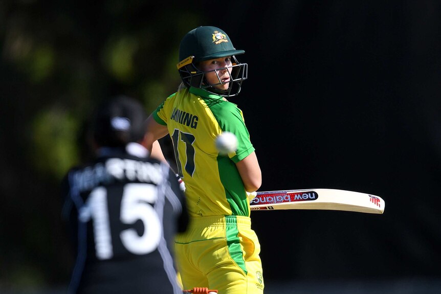 Meg Lanning looks behind her as the ball carries towards the New Zealand wicketkeeper, blurred in the foreground