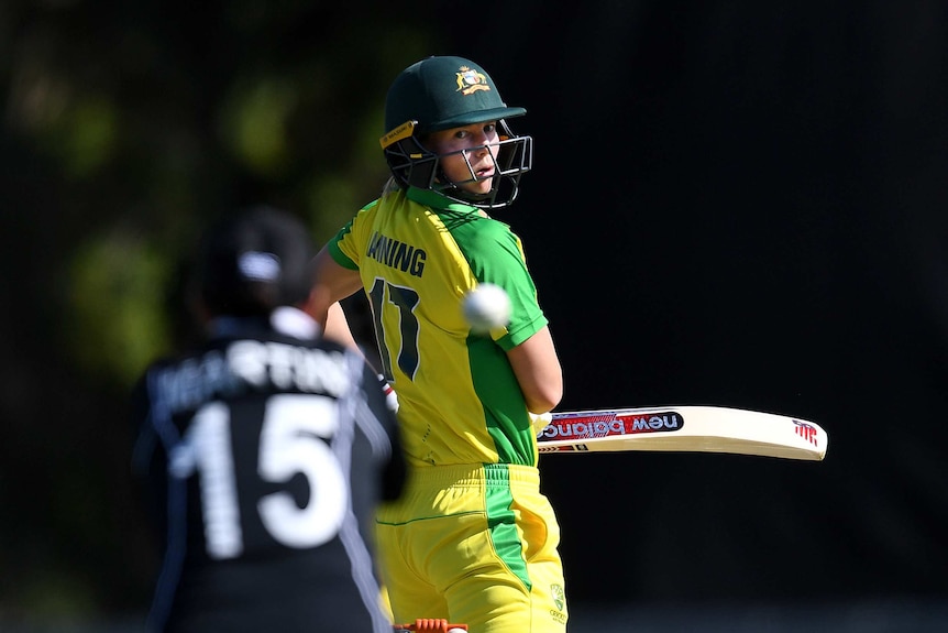 Meg Lanning looks behind her as the ball carries towards the New Zealand wicketkeeper, blurred in the foreground