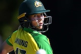 Meg Lanning looks behind her as the ball carries towards the New Zealand wicketkeeper, blurred in the foreground