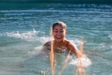 Mia Ayliffe-Chung laughing and swimming in a lake in a Facebook photo.