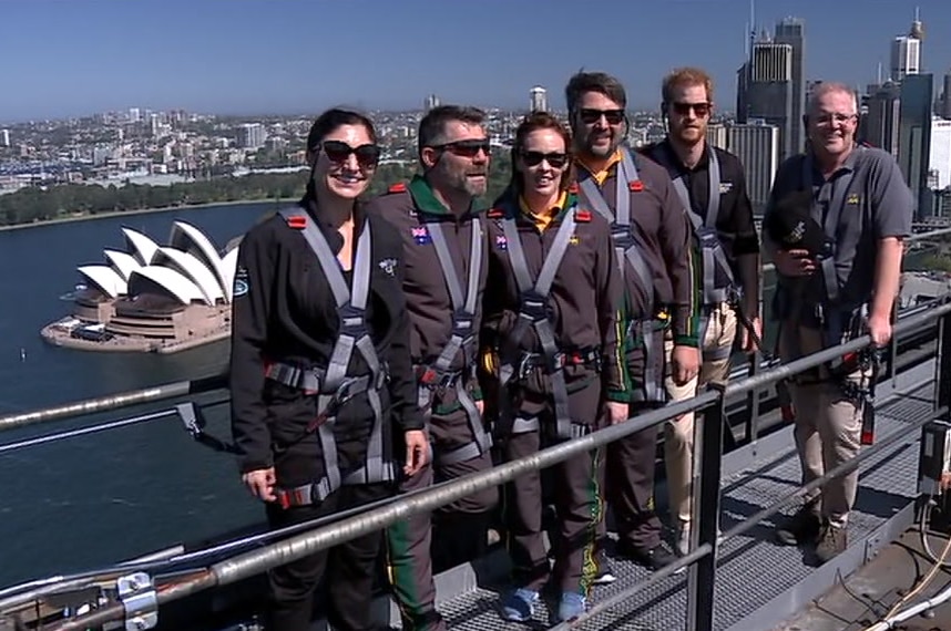 A group of people stand on top of a bridge