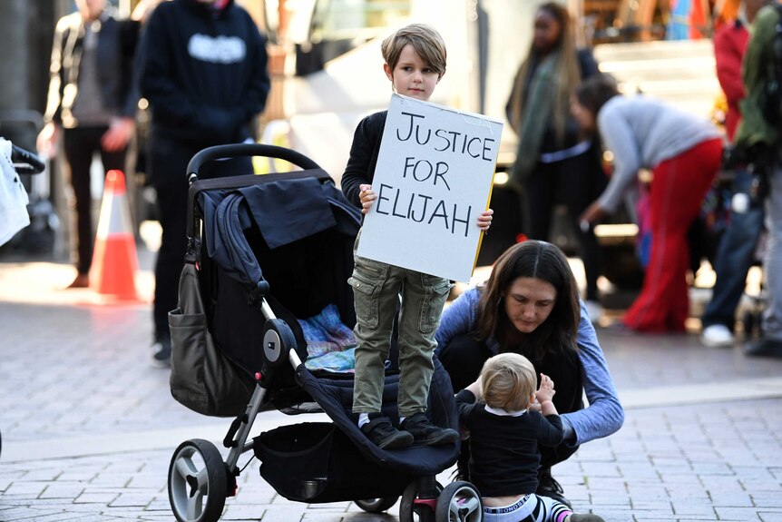 Child holds placard at Elijah Doughty protest
