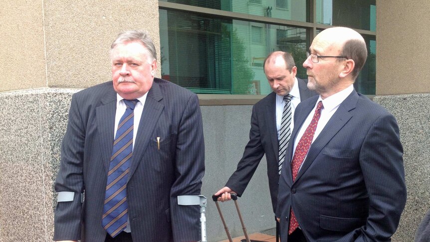 Tasmanian DPP Tim Ellis leaves Magistrates Court in Hobart with lawyer Michael O'Farrell (r),  March 2014.