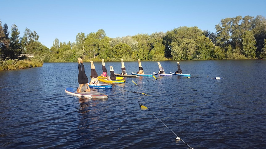 Yoga classes on Lake Burley Griffin.