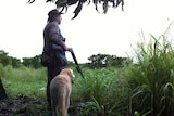 Bart Irwin and his retriever dog Roy wait for magpie geese