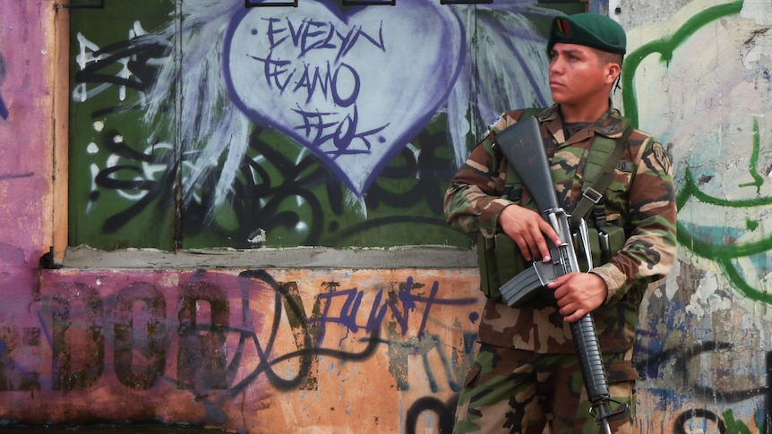 An El Salvadorean soldier patrols the streets