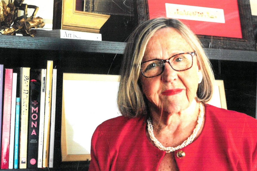 Headshot of Beth Heinrich standing in front of a bookcase.