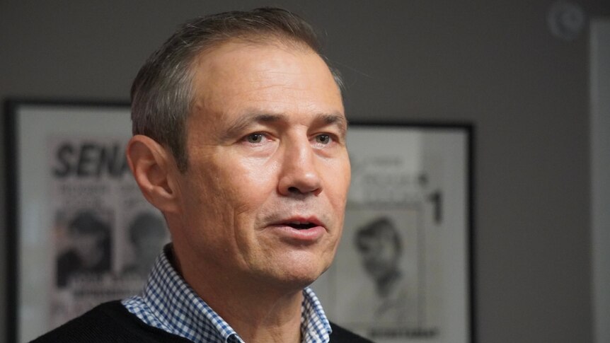 A close up of WA Health Minister Roger Cook wearing an open-necked shirt.