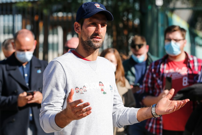 Novak Djokovic speaks to the media who are wearing masks during the press conference at Novak Tennis Centre in 2020