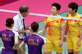 Tournament referee Torsten Berg speaks to players from China and South Korea during the badminton.