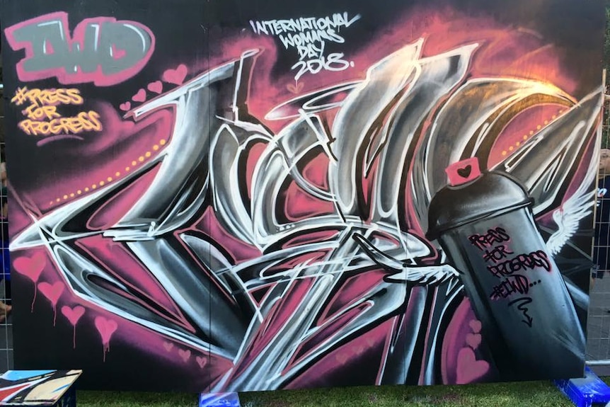 A piece of spray-paint art in greys and pinks to celebrate International Women's Day 2018.