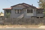 A Queenslander-style home in a suburban area.