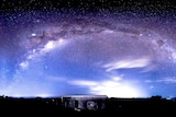 A container shed sits in the forground of the photo with a sign, 'Maleny Golf Club' as the Milky Way shines overhead.