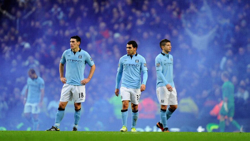 Derby dejection ... Carlos Tevez and team-mates trudge off.