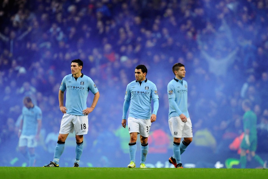 Derby dejection ... Carlos Tevez and team-mates trudge off.