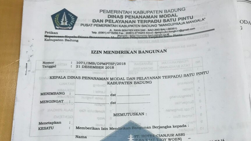 A photograph of a document written in Indonesian with official stamps on it