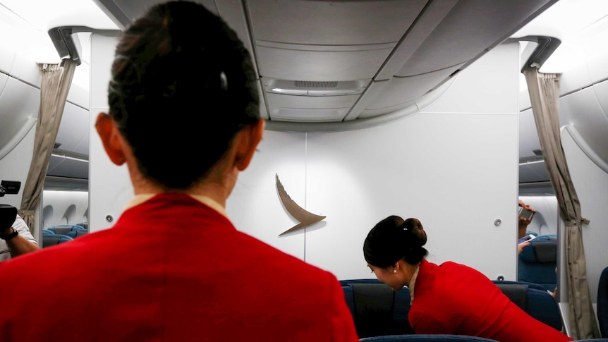 Two Cathay Pacific flight attendants on a plane