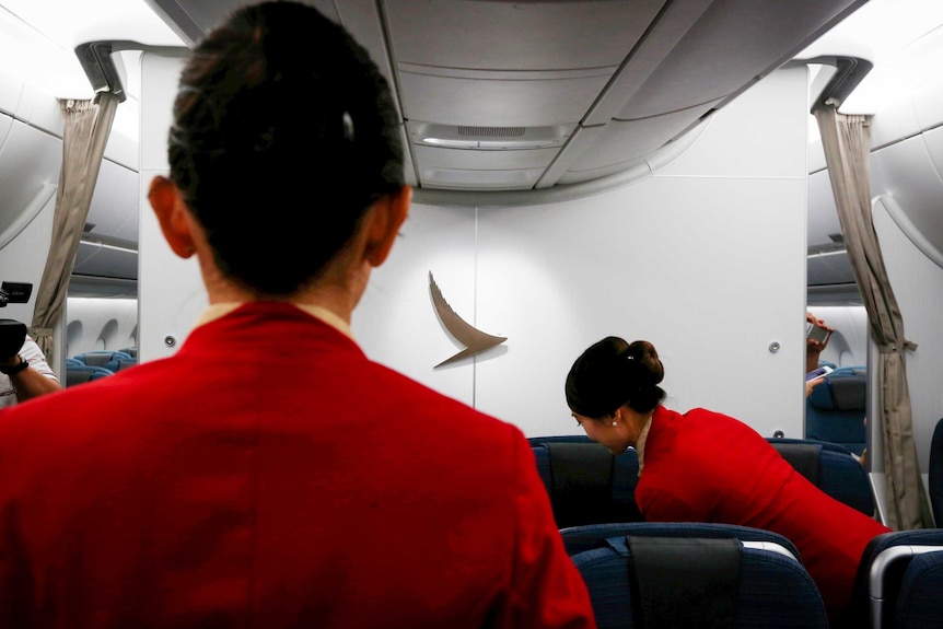 Two Cathay Pacific flight attendants on a plane