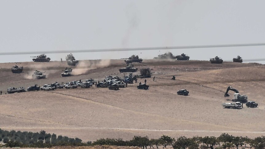 Turkish army tanks and pro-Ankara Syrian opposition fighters west of Jarabulus.