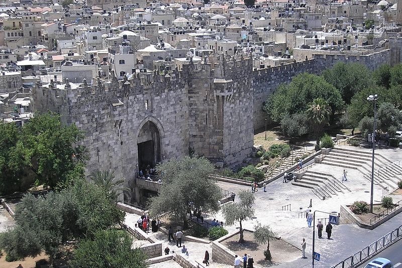 An elevated view of Jerusalem's Damascus Gate, showing the Old City behind it.