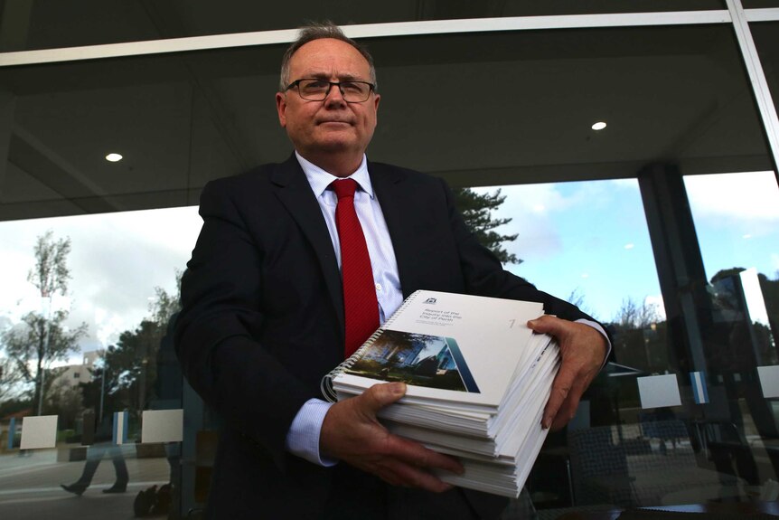 David Templeman holding the massive City of Perth report.