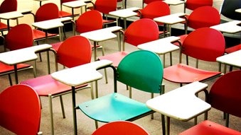 Desks and chairs in a public school classroom.